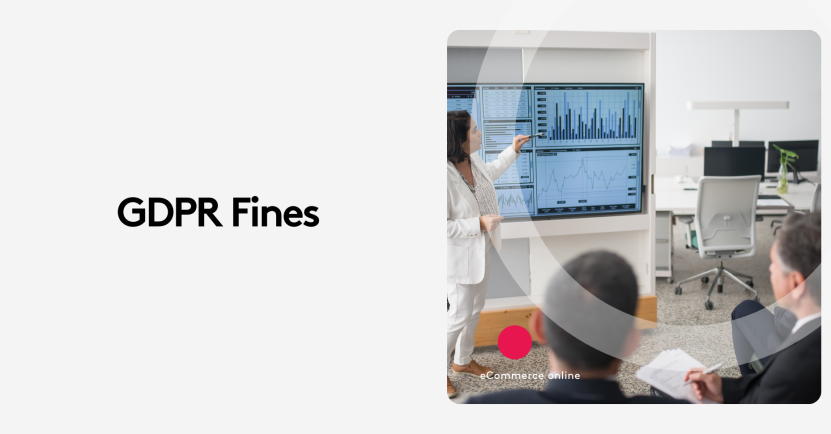 Woman presenting GDPR fines data on a screen in an office meeting.