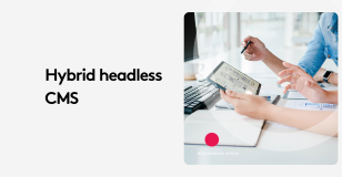 People discussing hybrid headless CMS using a tablet in an office setting.