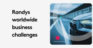 Text reading 'Randys worldwide business challenges' next to a car on a road.