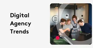 Team of four collaborating on laptops at a digital agency meeting.