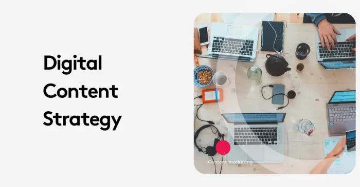 Overhead view of a digital content strategy meeting with laptops and devices on a wooden table.