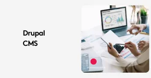 People using a tablet and laptop with analytics graphs in a Drupal CMS meeting